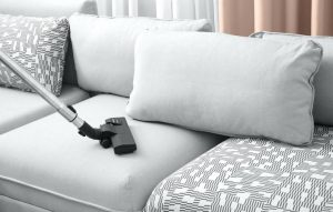 Using a vacuum cleaning to clean a couch